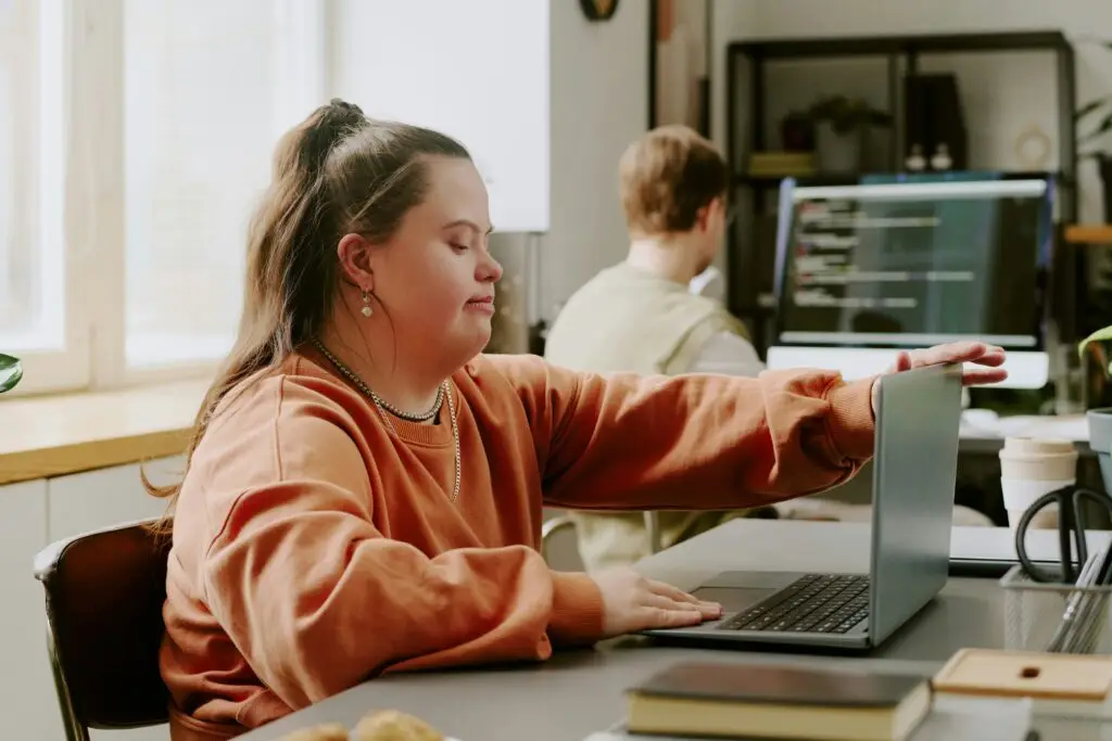 Young woman using a laptop at a desk in an office