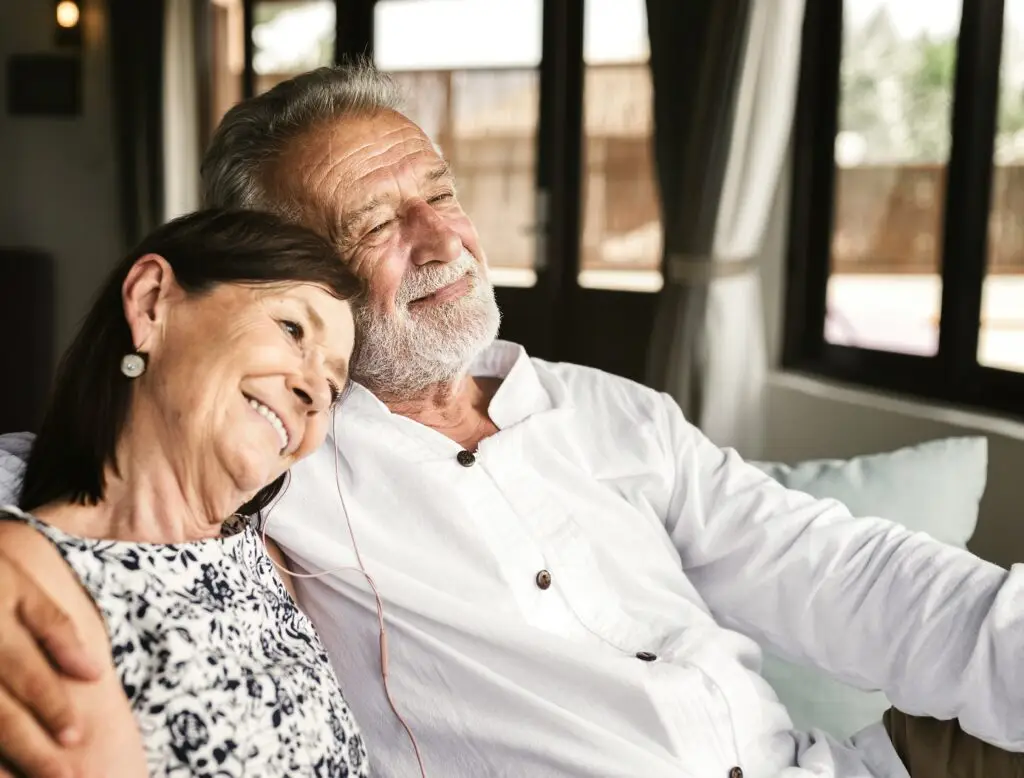 Older couple sitting close together on a couch