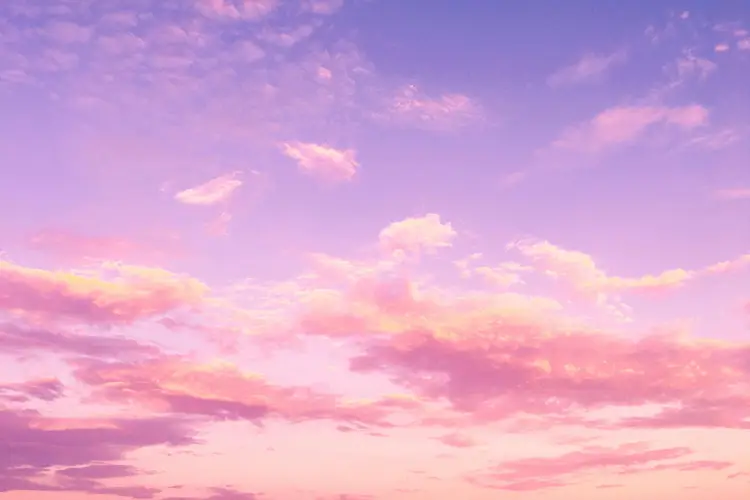 A picturesque sky filled with soft pink and purple clouds during sunset.