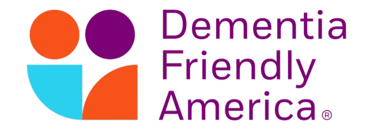 Logo for Dementia Friendly America. It features orange, purple, and blue abstract shapes on the left and the words Dementia Friendly America in bold purple text on the right, reflecting a supportive community for life care planning.