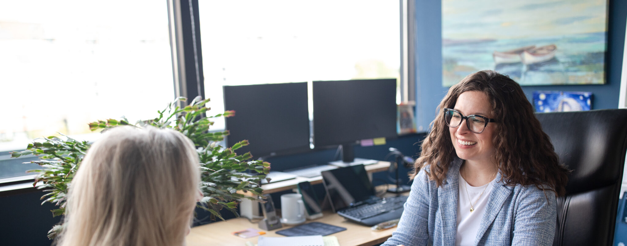 Lauren Fink, Founder, Attorney at Law, talking with someone across her desk