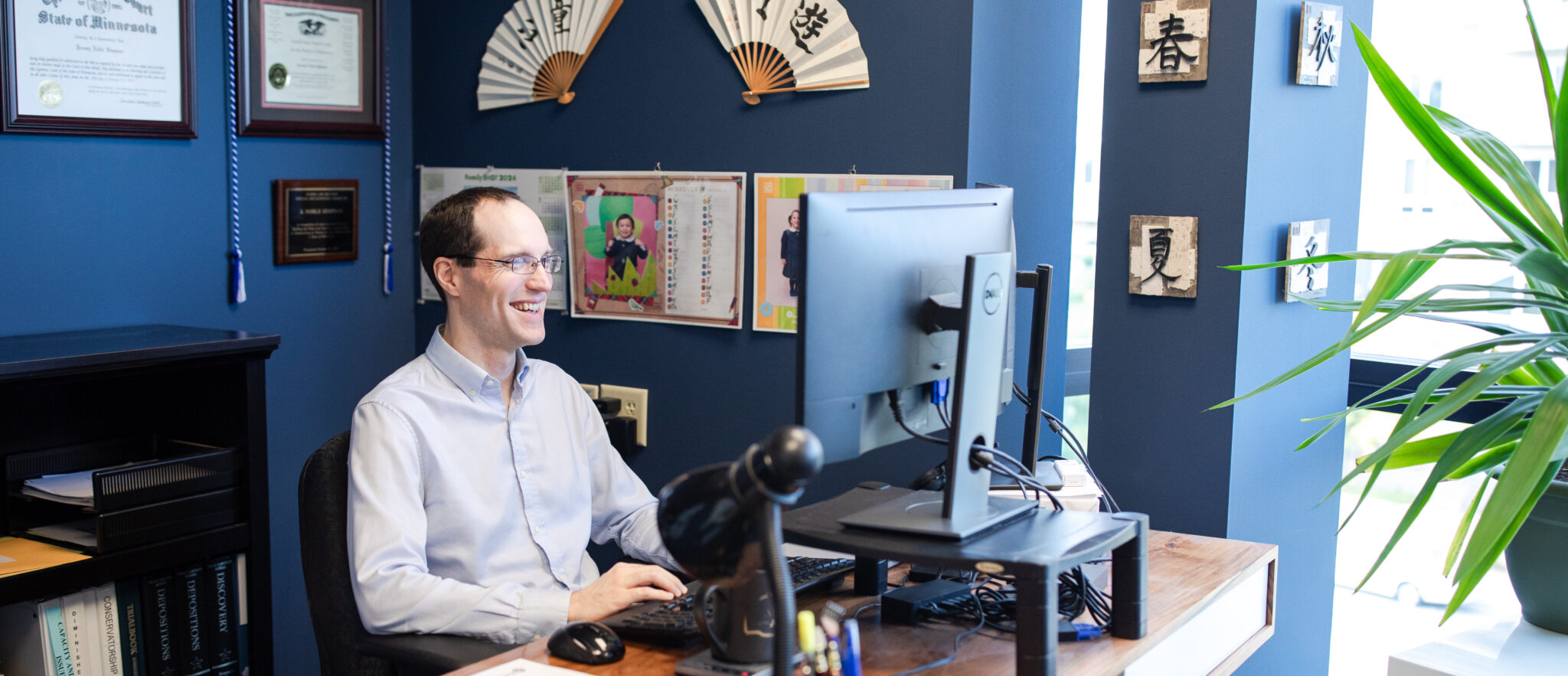 Noble Simpson, Partner, Attorney at Law, smiling at his desk