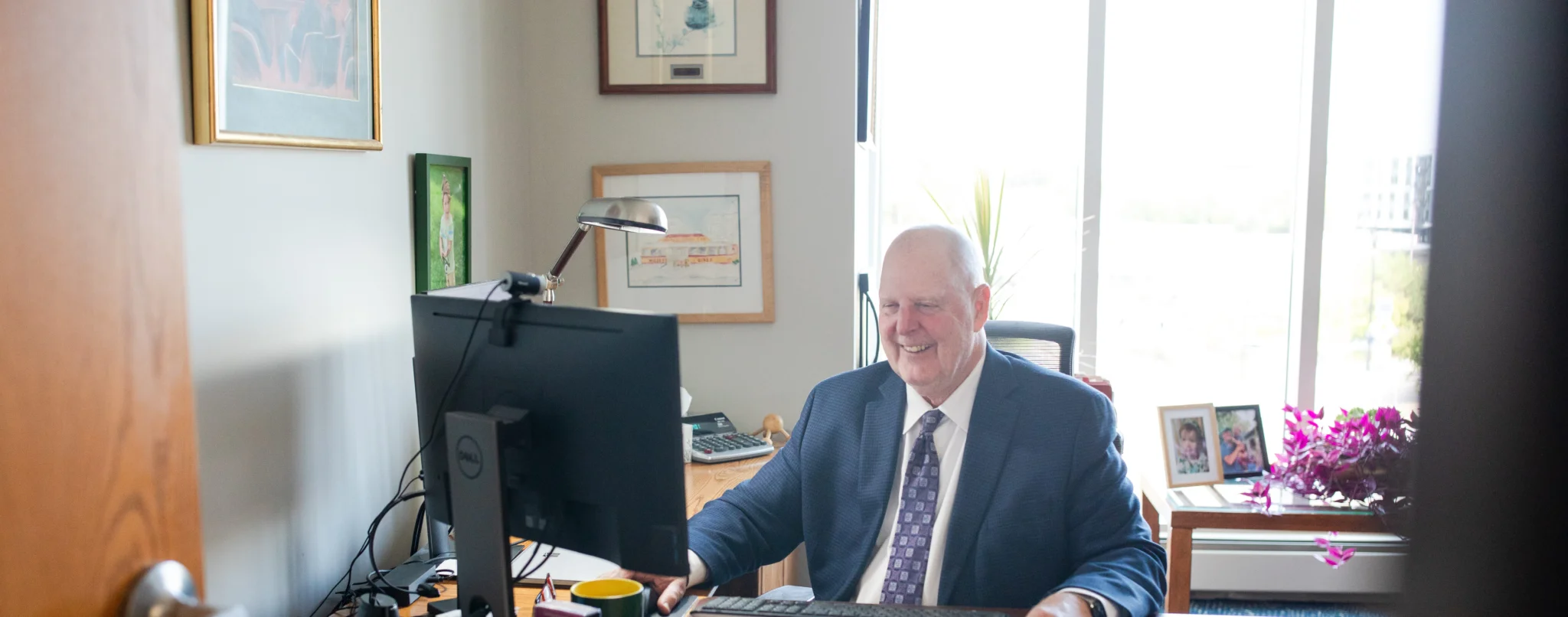 Randy Boggio, Partner, Attorney at Law, smiling at his desk